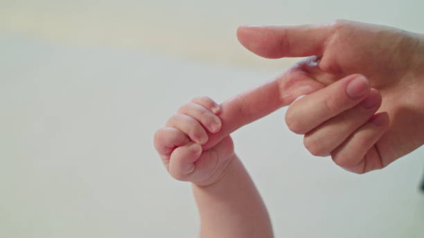 istock Mother's Finger is Holding Baby's Fist 886308336