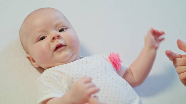 istock Baby is playing with Mother's Hands and start to cry 886308562