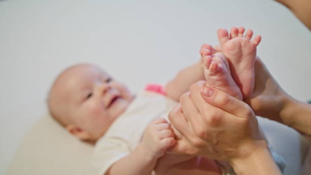 istock Mother Kissing Baby's Feet 886308954