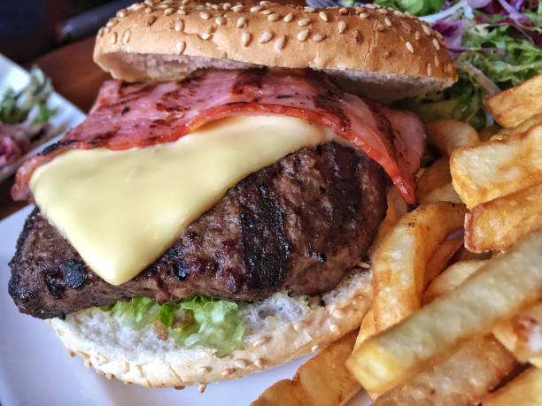 istock cheeseburger and potato fries on plate 886313600