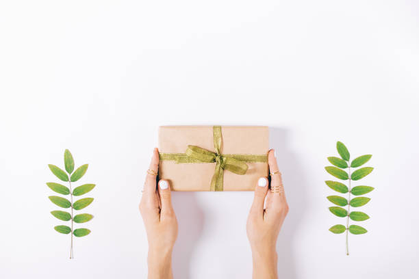 istock Female hands holding a box with a gift 886316152