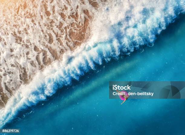 Aerial View Of Young Woman Swimming On The Pink Swim Ring In The Transparent Blue Sea In Oludenizturkey Summer Seascape With Girl Beautiful Waves Azure Water At Sunset Top View From Drone Travel Stock Photo - Download Image Now