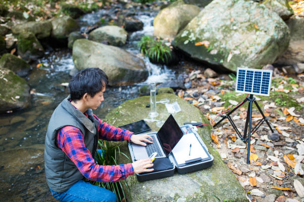 istock A researcher entering water quality data into a computer at a solar powered field laboratory 886335566