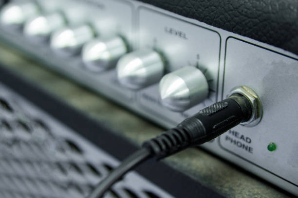 istock close up guitar amplifier connected with black cable audio jack 886338768