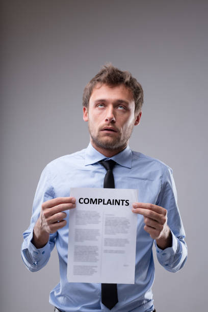 istock Man rolling his eyes over a Complaints notice 886354606