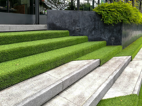 Hardscape of modern building stairway decoration with artificial grass / park and outdoor design conceptual