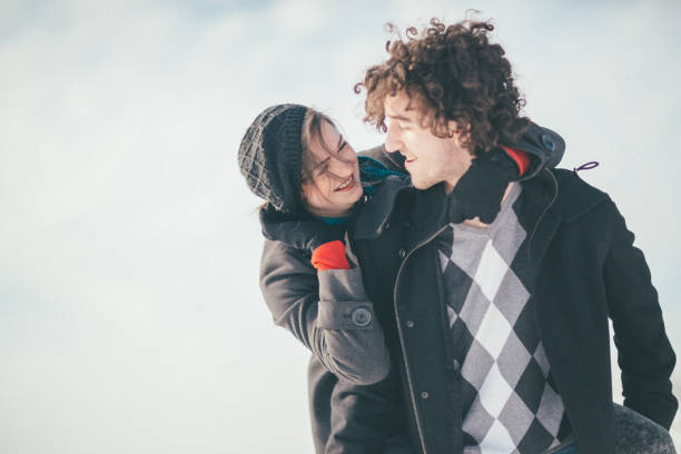 istock Smiling young couple having fun in the snow 886365432