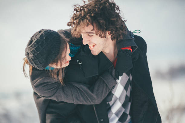 istock Smiling young couple having fun in the snow 886365500