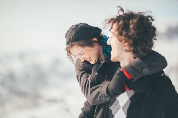 istock Smiling young couple having fun in the snow 886365542