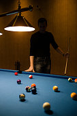 istock Man with snooker stick 886369720