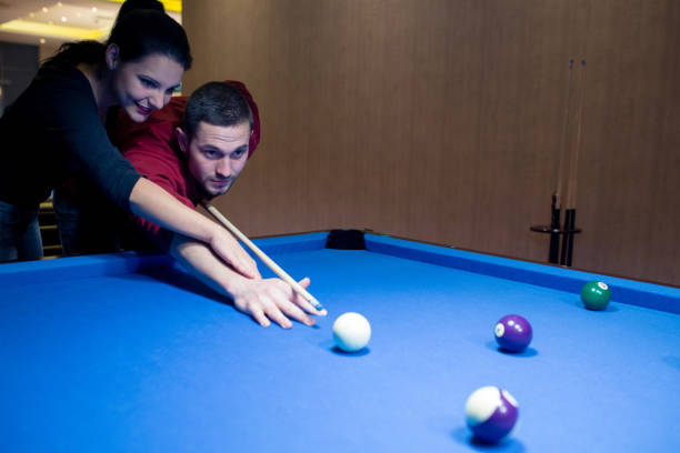 istock Couple playing billiards together 886374266