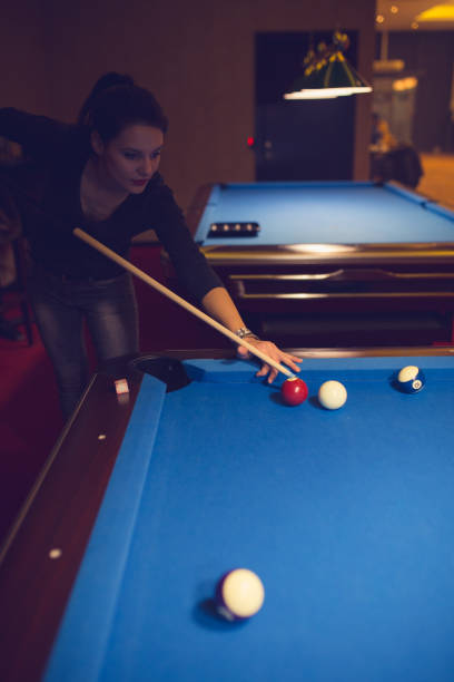 istock Pretty woman playing billards 886374282