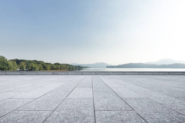 istock empty marble floor with beautiful lake in blue sky 886402070