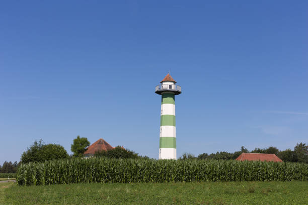 water reservoir tower under blue sky and green field in south germany rural countryside on a hot summer day in july