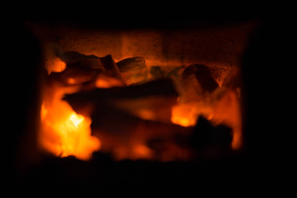 istock Hot combustion with ash in the fireplace. 886402526