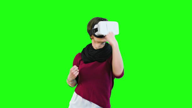 Woman Boxing with a VR Headset On woman with glasses of virtual reality play boxing game on green screen background 2933 stock pictures, royalty-free photos & images