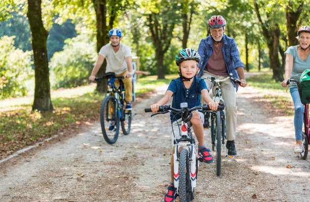 istock Family Cycling Together Through Park 886432306