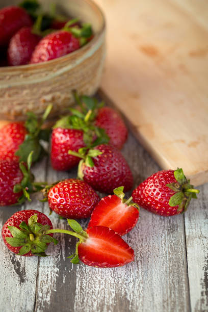 istock Strawberry In a bowl On a Wooden Background 886432656