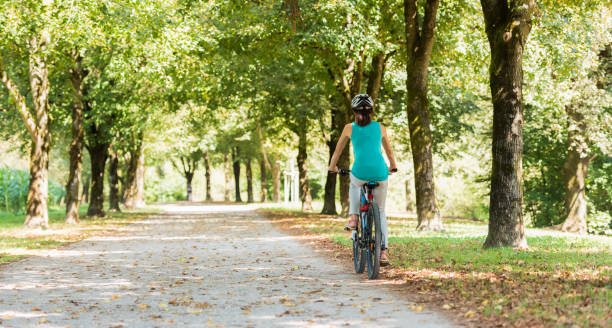 istock Mature Woman Cycling 886436842