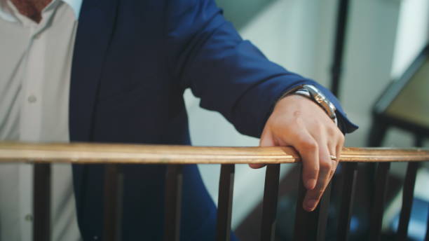 istock A Man Walking Up the Stairs Holding the Bannister 886445310