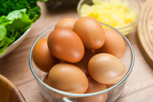 istock Pil of Eggs on Bowl with Salad Set on Table 886450396