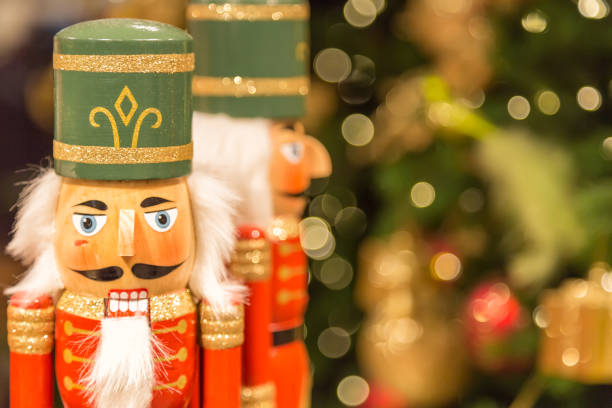 Soldier nutcracker statues standing in front of decorated Christmas tree with bokeh lights Soldier nutcracker statues standing in front of decorated Christmas tree with bokeh lights. nutcracker photos stock pictures, royalty-free photos & images