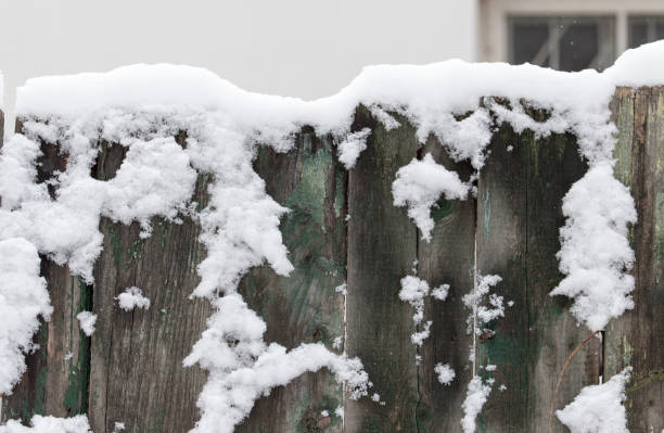 istock Snow on the wooden fence as a backdrop 886465478
