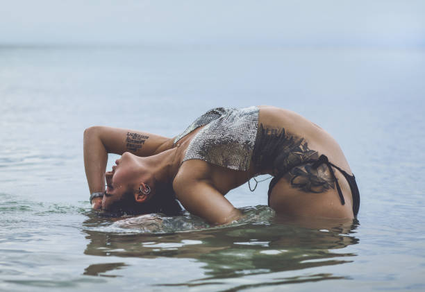 istock Sensual woman bathing in the sea 886465678