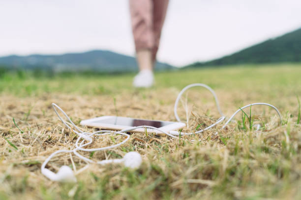 smartphone with earphones on foreground,blurred background.