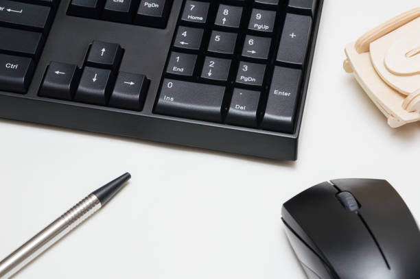 istock Computer keyboard and mouse, pen, wooden car isolated on white background 886479224