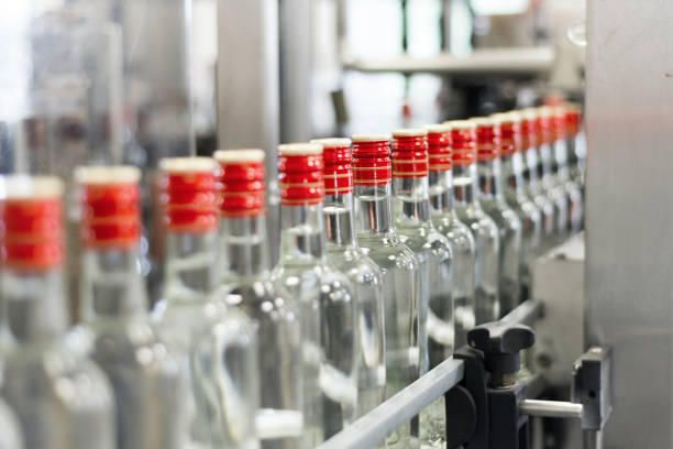 istock Bottles with vodka on the conveyor 886479440
