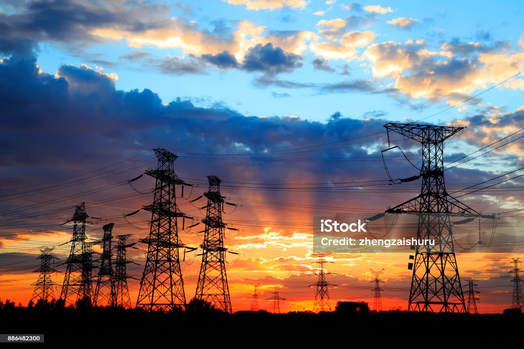 The silhouette of the evening electricity transmission pylon Power Line Stock Photo