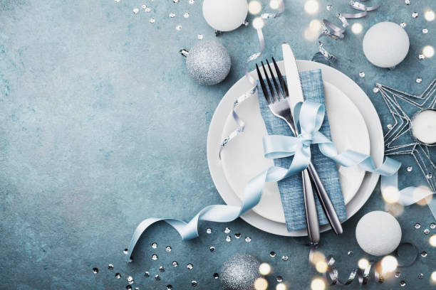 Elegant christmas table setting for holiday dinner top view. Bokeh effect.