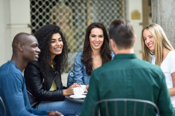 istock Multiracial group of five friends having a coffee together 886490022