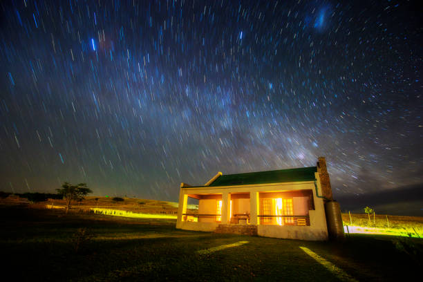 istock Star trail over country cottage 886494500