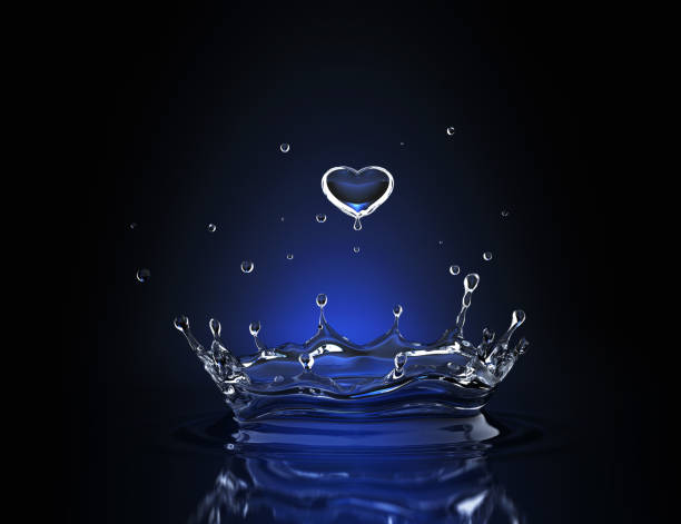 istock Water drop in form of heart in blue spot light 886499966