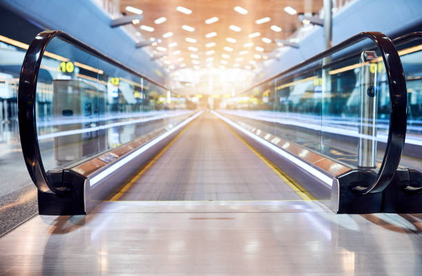 The way towards the plane Shot of a moving walkway in the airport travolator stock pictures, royalty-free photos & images