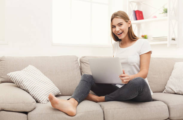 istock Young girl with laptop indoors 886500990