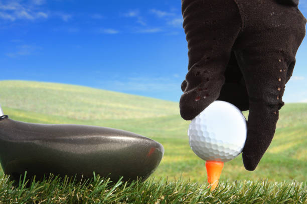 istock hand placing golf ball to a tee 886510738