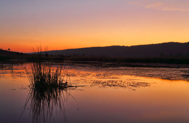 istock Sunset  over lake with mountains 886510956