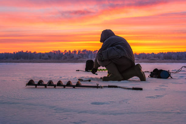 winter sport ice fishing winter sport, winter fishing fishing outside on the ice man ice fishing stock pictures, royalty-free photos & images