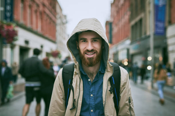 Cropped portrait of a handsome young man walking through the city