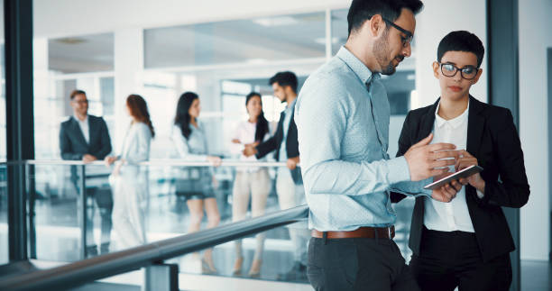 istock Happy business colleagues in modern office 886514364