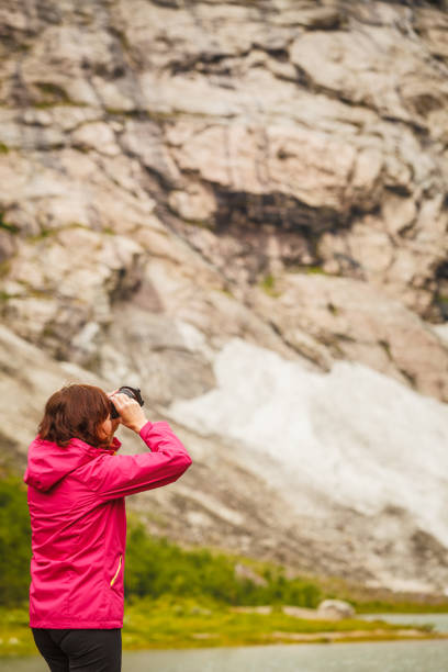istock Tourist photographer with camera in mountains Norway 886514830