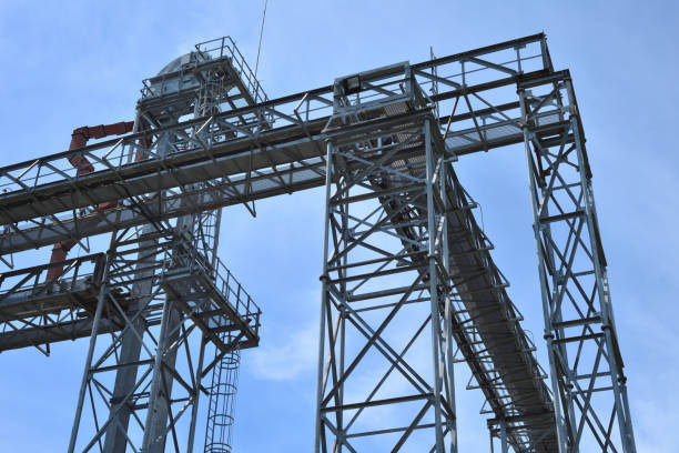 istock Fragment of metal grain elevator in facility with silos. 886520936