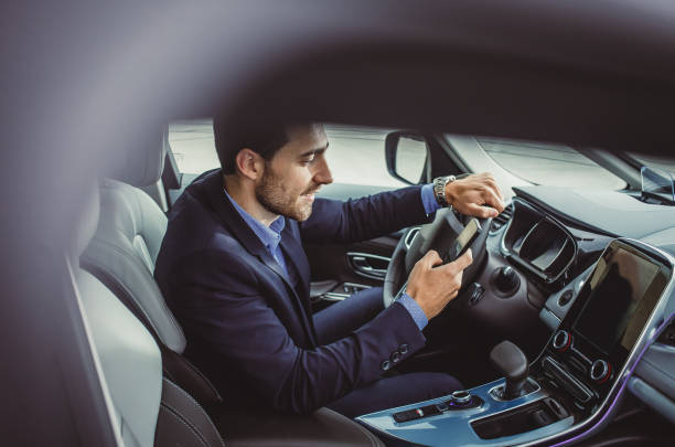istock Businessman in the Car Using Smart Phone 886520948