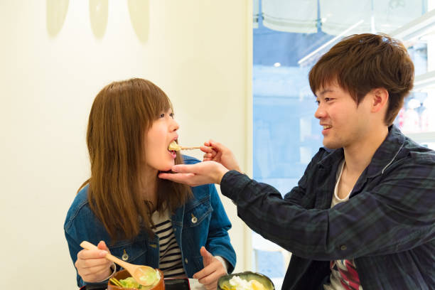 istock Smiling young couple eating dessert 886521116