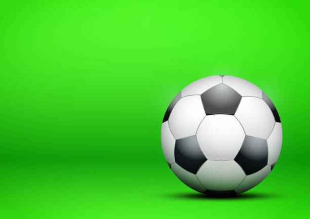 istock Football Soccer ball on bright green background 886529562