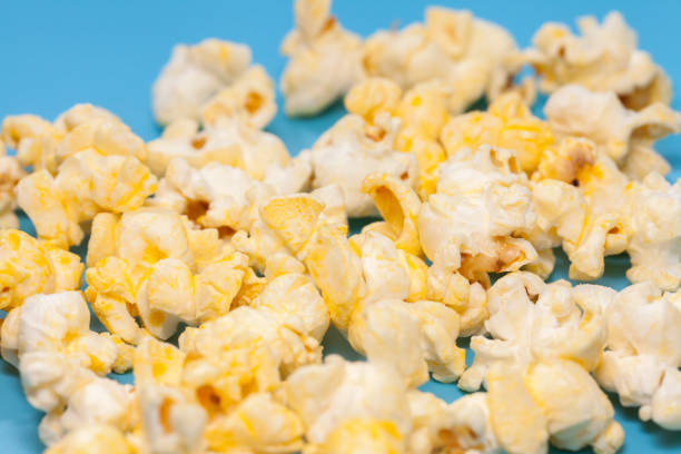 istock popcorn in wooden on blue background 886530318