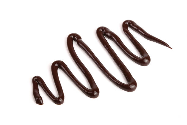 istock Hot melted chocolate pouring isolated on white background, top view 886532834